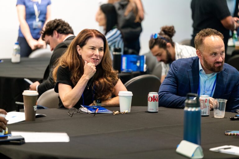 Attendee smiling at a workshop table – Creative Soul Studios