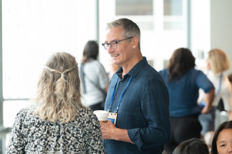 Attendees chatting during a conference break – Creative Soul Studios