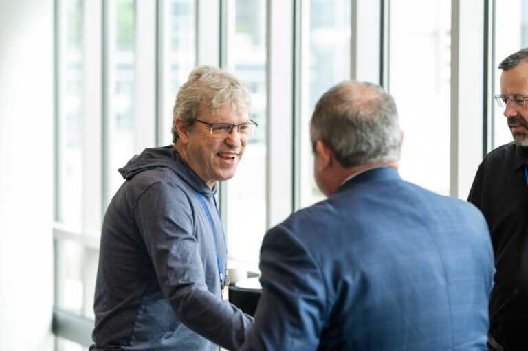 Attendees in conversation at a conference – Creative Soul Studios