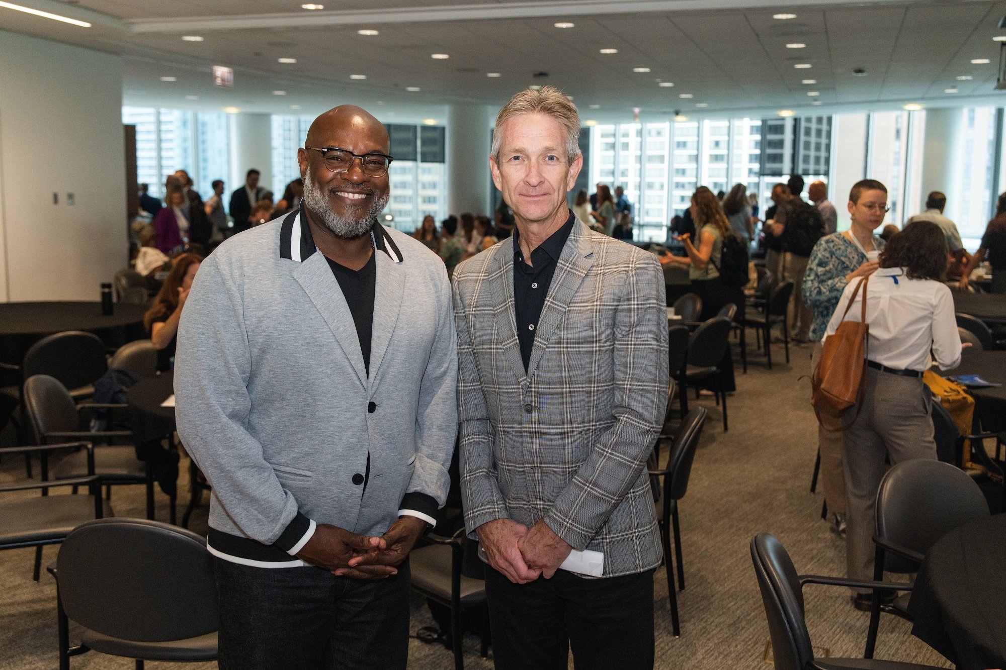 Two attendees posing at the AWE symposium, Gleacher Center Chicago