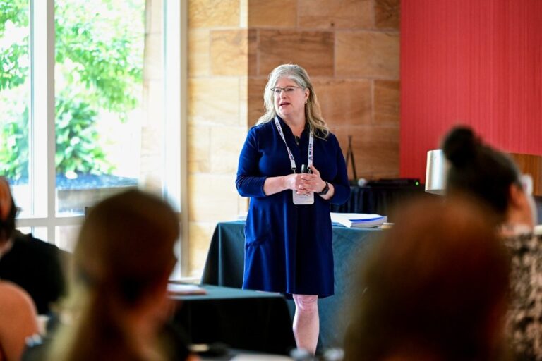 Speaker presenting at a conference session