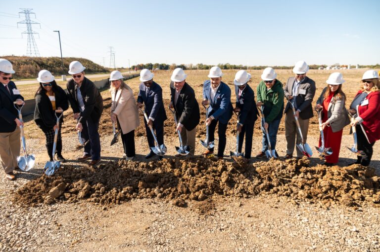 Executives breaking ground at a Coca-Cola groundbreaking ceremony