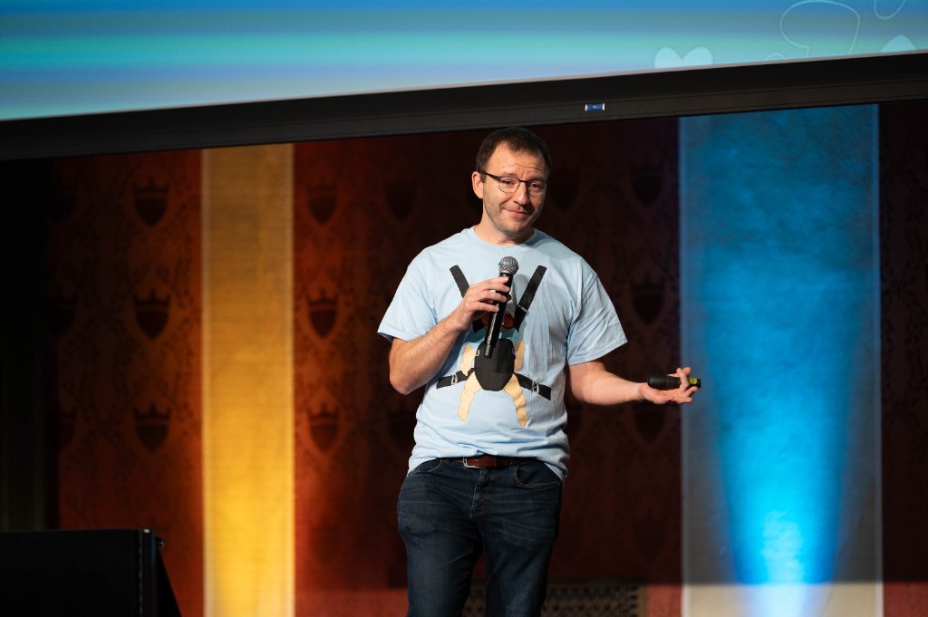 Presenter demonstrating a baby carrier on stage at a P&G Baby Care event, Cincinnati Music Hall