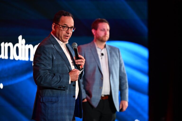 Two speakers on stage at the NeoStella conference