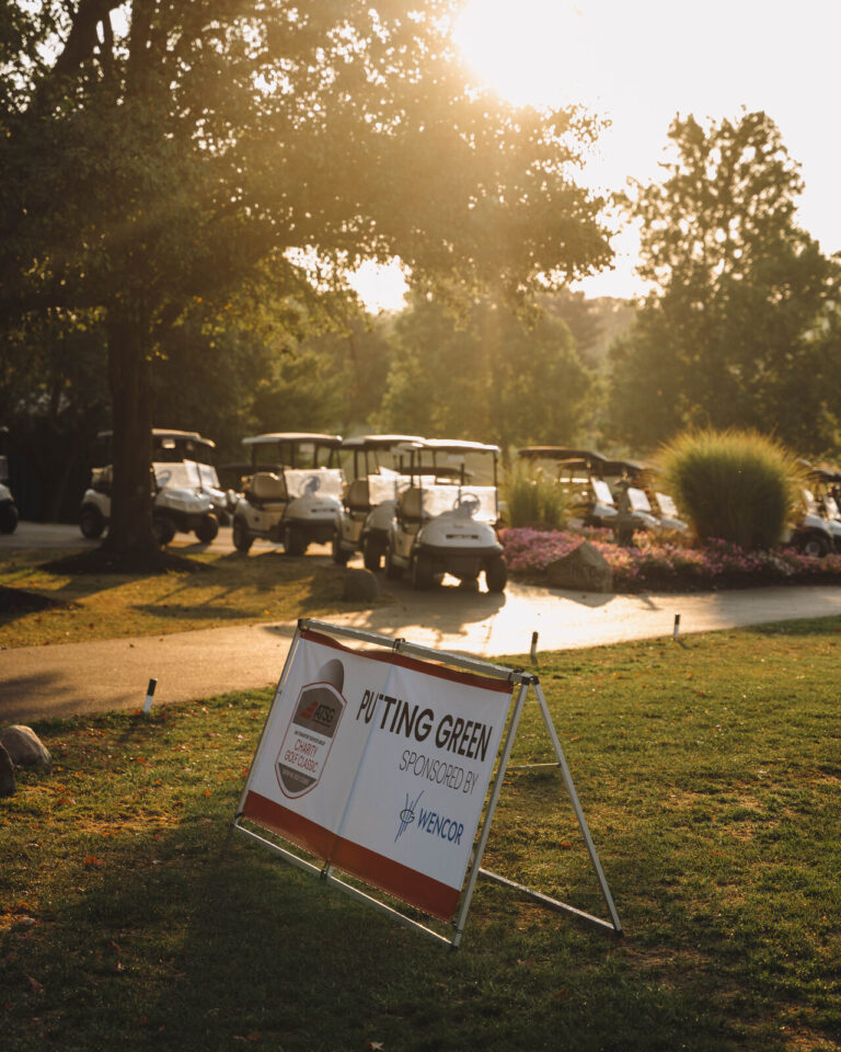 Sponsor sign on the course in morning light at the ATSG Charity Golf Classic 2025