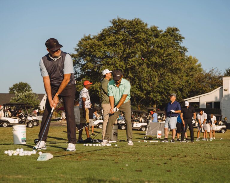 Golfers warming up on the driving range at the ATSG Charity Golf Classic 2025