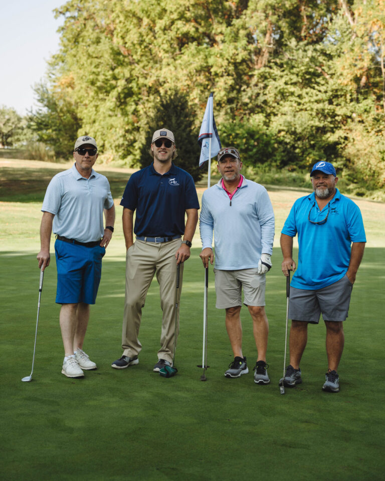 Foursome posing on the course at the ATSG Charity Golf Classic 2025