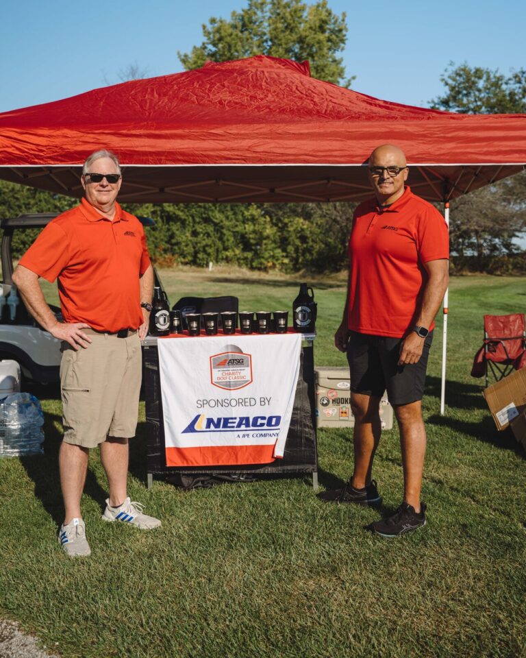 Sponsors at a hole sponsor tent at the ATSG Charity Golf Classic 2025