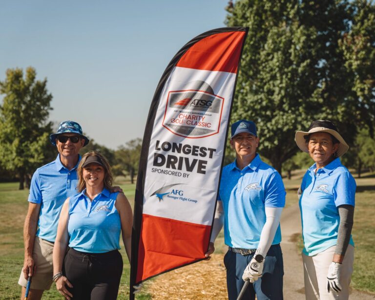 Team posing at the longest drive contest at the ATSG Charity Golf Classic 2025