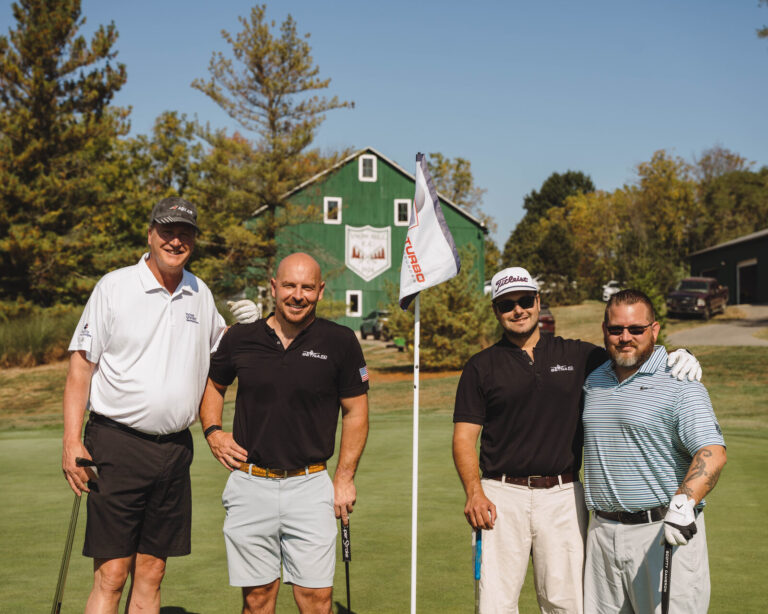 Golfers celebrating on the green at the ATSG Charity Golf Classic 2025