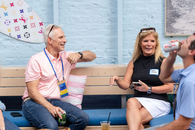Attendees relaxing on rooftop benches at the AWE Symposium reception at Joy District, Chicago