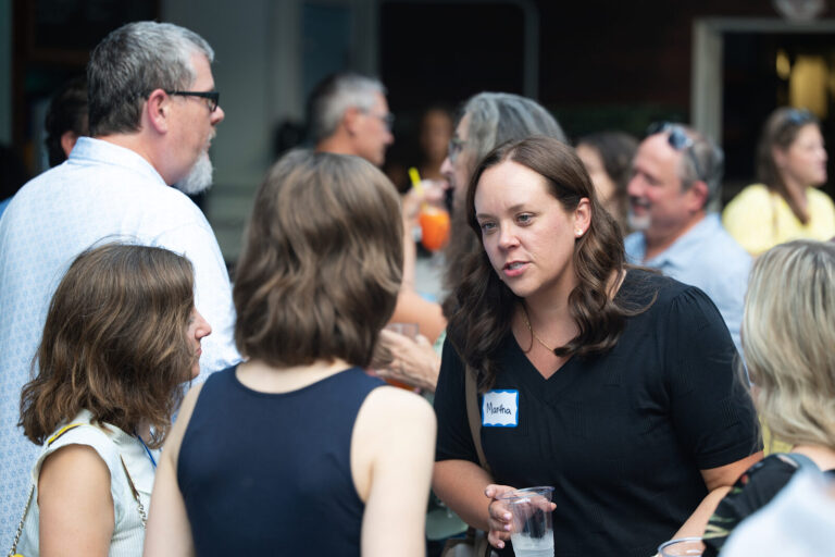 Attendees mingling in the crowd at the AWE Symposium reception at Joy District, Chicago