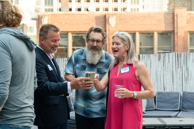 Guests greeting each other at the AWE Symposium reception at Joy District, Chicago