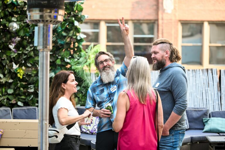 Attendees networking at the symposium reception at Joy District in downtown Chicago