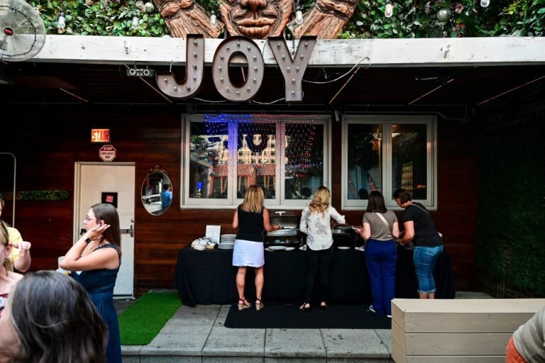 Guests at the buffet during the symposium reception at Joy District, Chicago