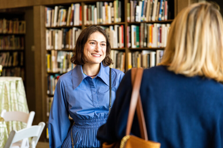 Guest smiling during conversation at the Cincinnati Art Museum reception
