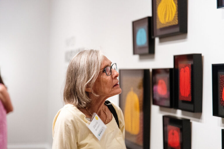 Guest viewing artwork during a museum tour at the berkleyOne event