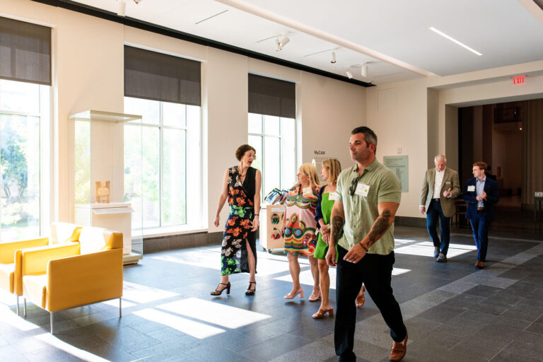 Guests walking through a gallery hall at the Cincinnati Art Museum