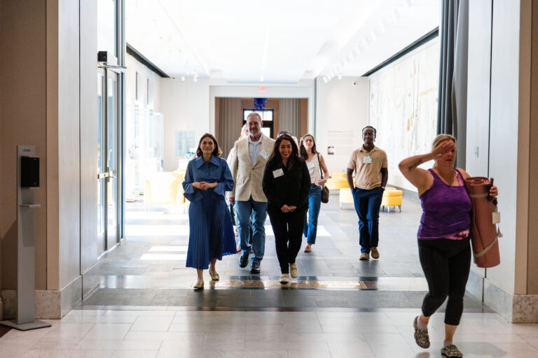 Guests walking down a sunlit corridor at the Cincinnati Art Museum