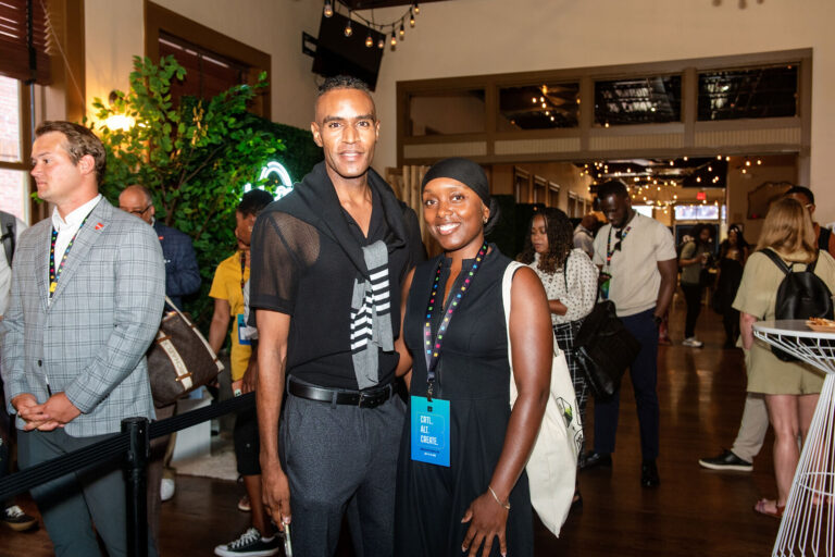 Attendees posing in the event hall at The Backstage Event Center