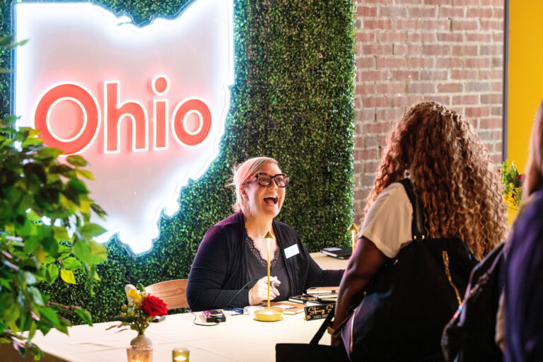 Attendees in the Ohio neon sign lounge at Black Tech Week 2026