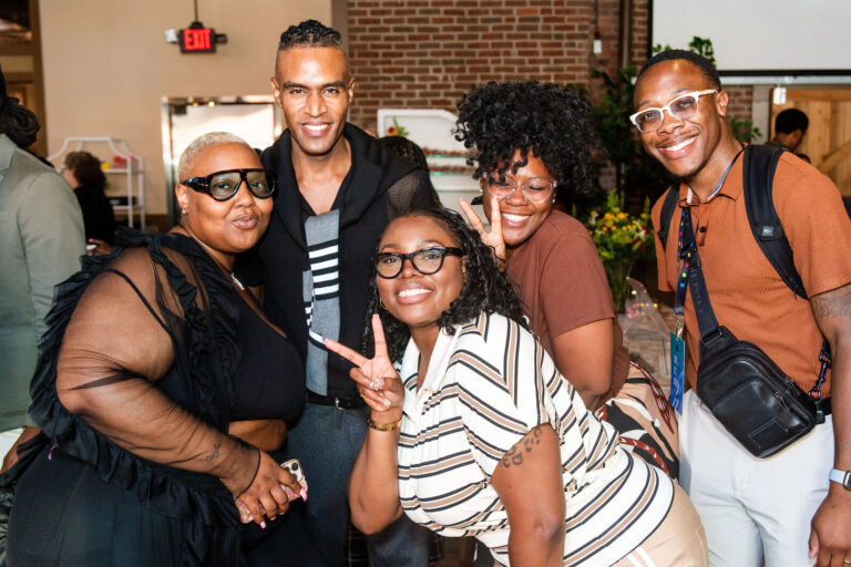 Attendees posing together at The Backstage Event Center