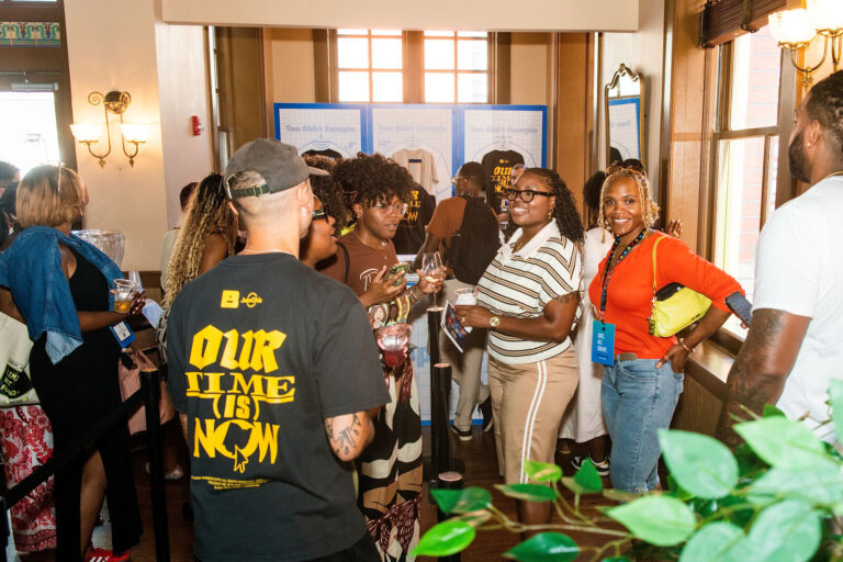 Attendees gathered at the T-shirt printing station