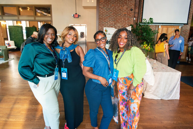 Group of attendees posing in the hall at The Backstage Event Center