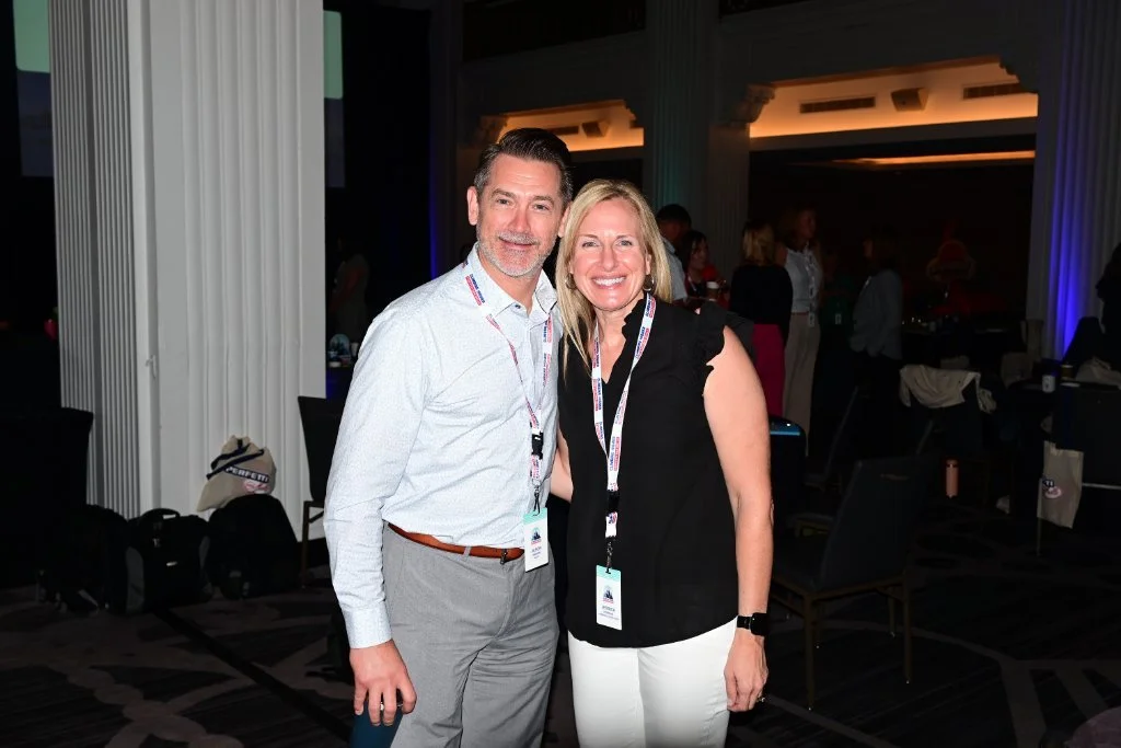 Two attendees posing for a photo at a corporate event – Creative Soul Studios