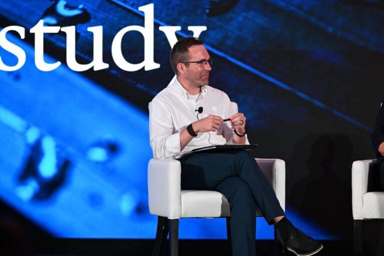 Panelist seated on stage during a conference discussion – Creative Soul Studios