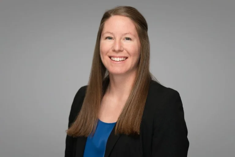 Smiling woman in a dark blazer, corporate team headshot – Creative Soul Studios