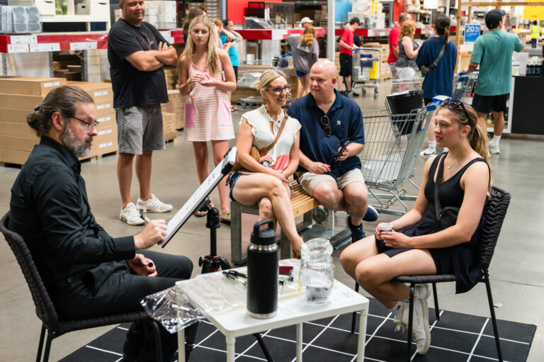 Caricature artist sketching graduates and their families at the IKEA Grad Bash Cincinnati 2023