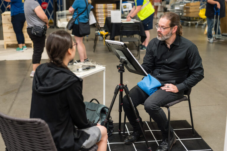 Caricature artist drawing a guest at the IKEA Grad Bash Cincinnati 2023