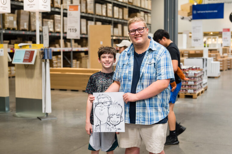 Graduate and family showing off a caricature at the IKEA Grad Bash Cincinnati 2023