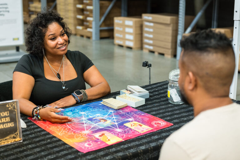 Guest at a card reading station at the IKEA Grad Bash Cincinnati 2023
