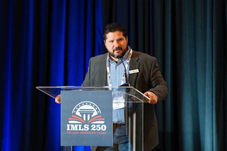 Presenter speaking at the IMLS 250 podium in St. Louis