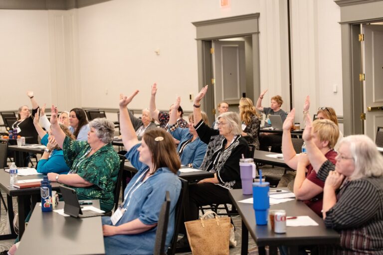 Librarians raising their hands during a breakout session at IMLS Library Convenings St. Louis