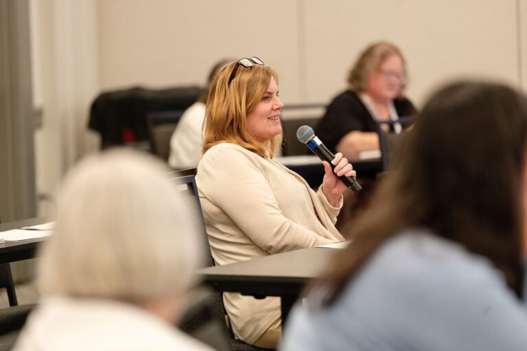 Attendee sharing ideas with a microphone at a breakout session in St. Louis