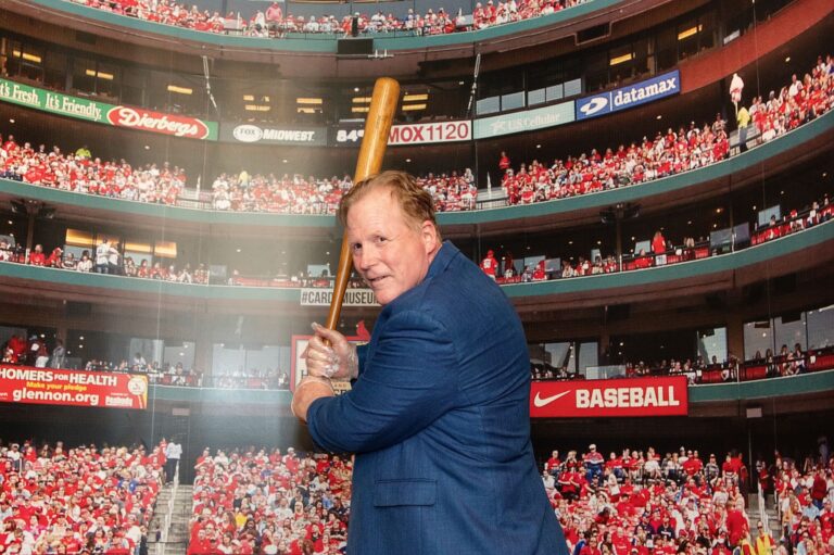 Attendee taking a swing in the Cardinals batting experience at Busch Stadium