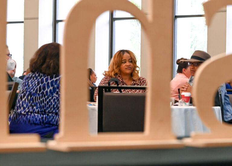 Attendees seen through the Shift letter display at LeaderShift