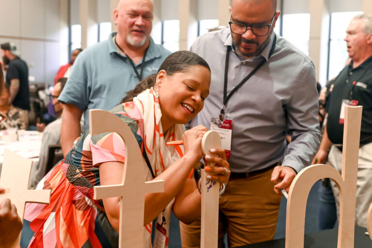 Attendees posing with the Shift letters at the Dayton Convention Center