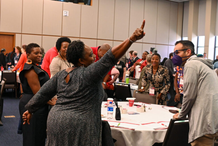 Attendees cheering during an interactive LeaderShift session