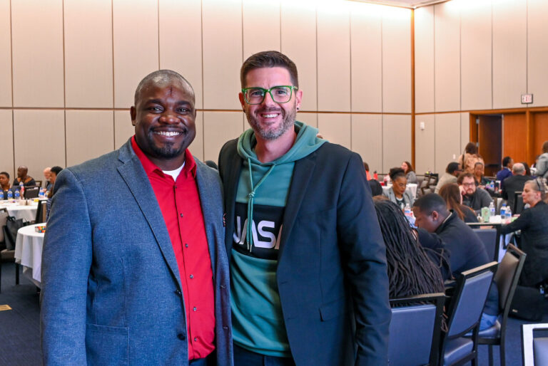 Two attendees posing in the ballroom at LeaderShift in Dayton