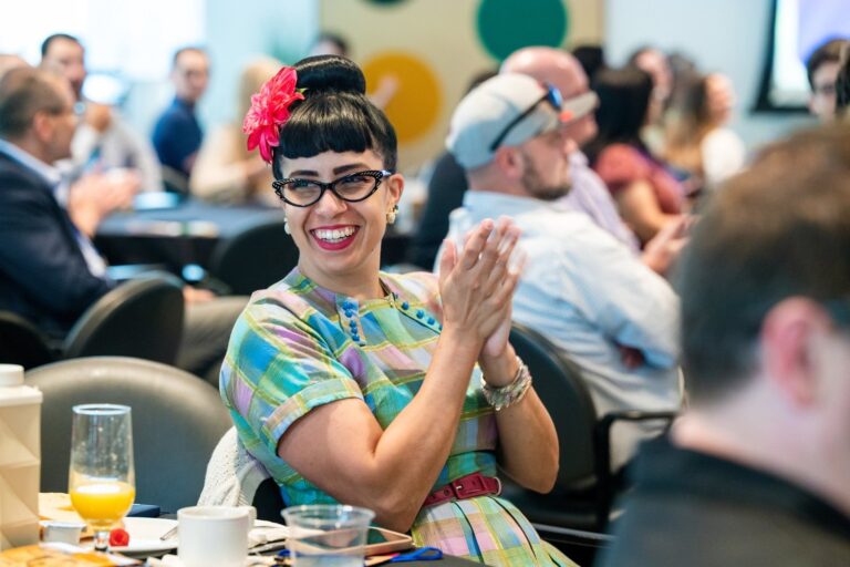 Attendee applauding during a conference session – Creative Soul Studios