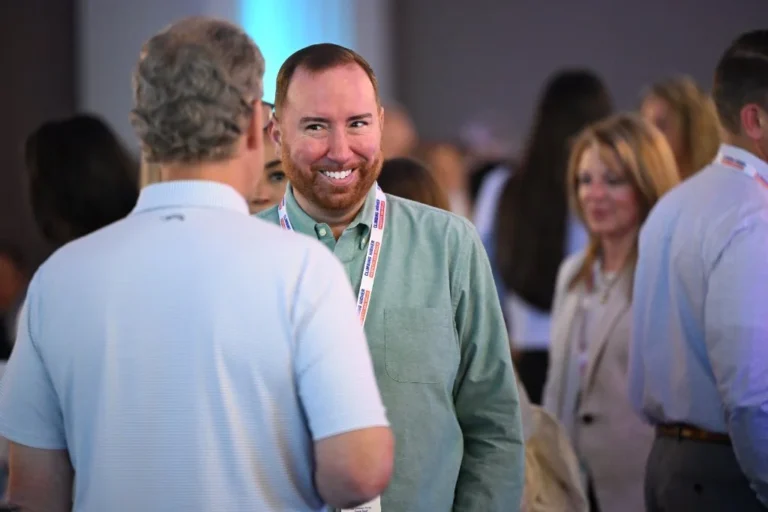 Smiling attendee with a lanyard during networking – Creative Soul Studios