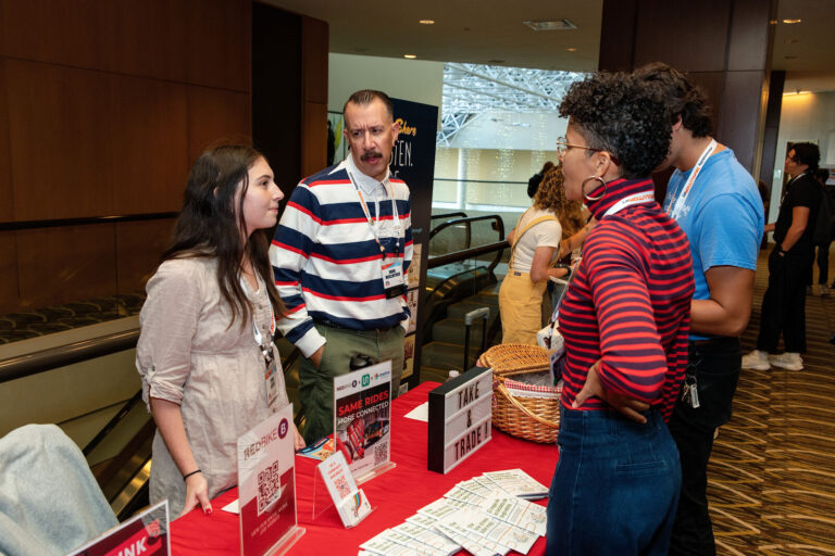 Attendees visiting the Red Bike booth at NABSA 2026