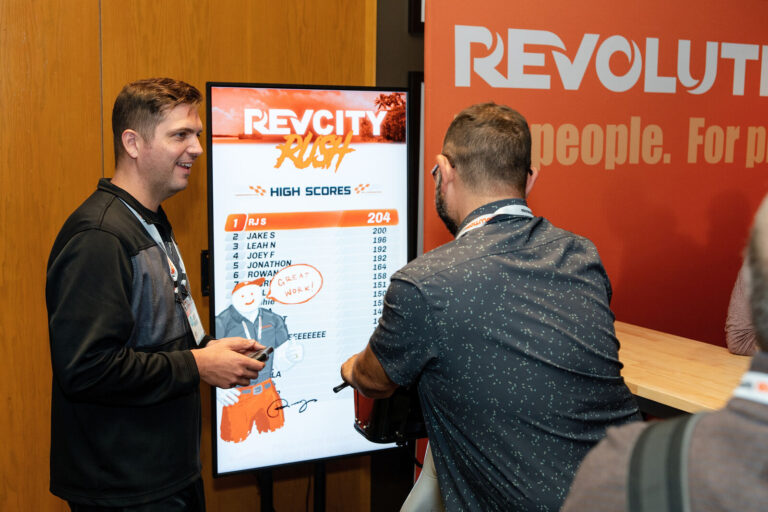 Attendees playing the RevCity Rush game at the Revolution booth