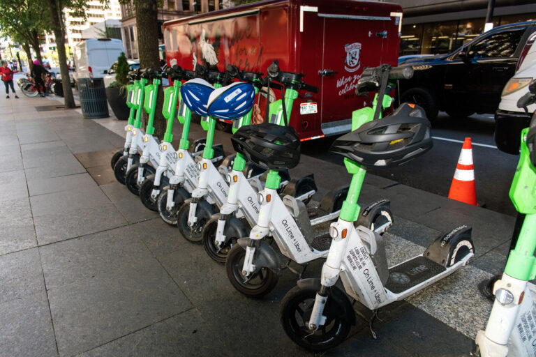 Shared e-scooters lined up on a downtown Cincinnati street during NABSA