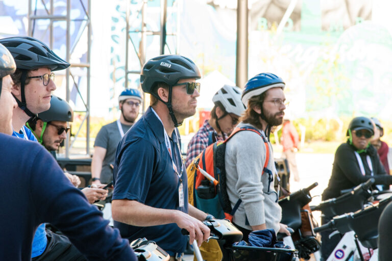 Riders in helmets on the NABSA group ride through Cincinnati
