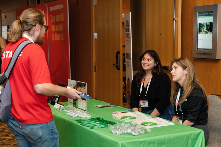 Attendee visiting an exhibitor table in the NABSA expo
